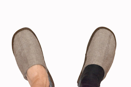 Legs in a brown sleepers and a black sock