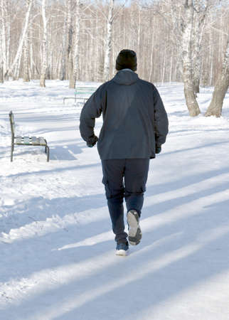 person jogging in the snow forestの写真素材