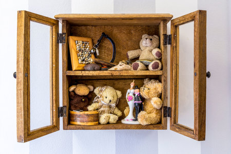 Old rustic wood wall mounted display cabinet, items, toys and memories.の写真素材
