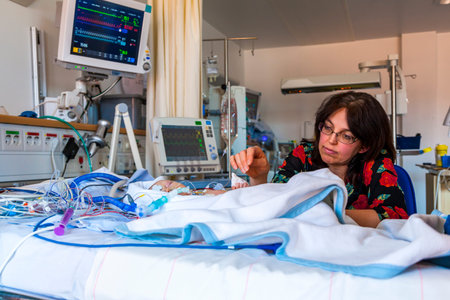 Mother with sick baby, child, intensive care unit.