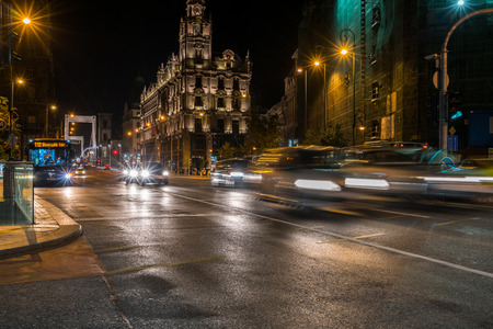 Budapest, Hungary - September 26, 2017: Night shot of busy street near Elisabeth Bridge in Budapest Hungary with cars moving fast. A bus stops to pick up passengers, buildings and incidental people in the background.のeditorial素材