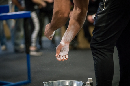 Close up selective focus of male hands preparing with chalk magnesium before exercise.の写真素材