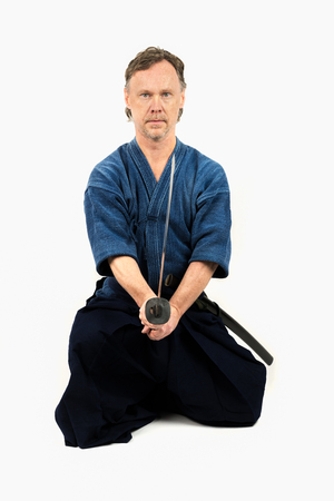 Caucasian male training Iaido, japanese sword sport. Sitting position.の写真素材