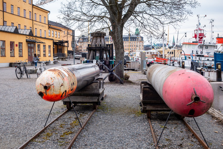 STOCKHOLM, SWEDEN - APRIL 6, 2015: Front view of two old submarine torpedoes outside the museum Torpedverkstaden in Stockholm Sweden April 6, 2015. Incidental people in the background.のeditorial素材