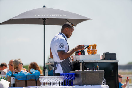 BRO, SWEDEN - JUNE 30, 2019: Close-up view of customers and staff at an outdoor restaurant with a...