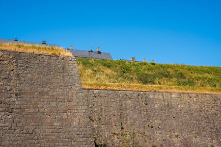 Beautiful summer landscape with a historic and old massive medieval defense wall at Varbergs Fortress in Sweden.の写真素材