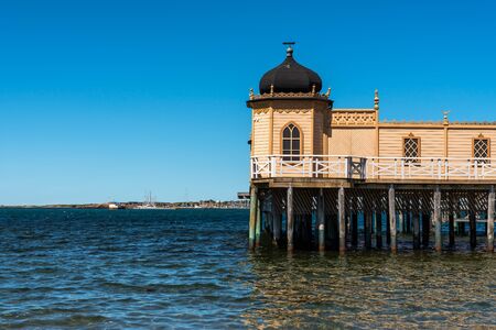 Summer seaview of the famous old historic wooden bathhouse Varbergs Kallbadhus. A cold water public bath located in the ocean with a bridge ashore in Sweden.の写真素材