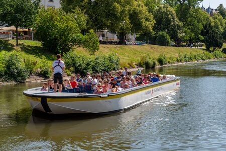 GOTHENBURG, SWEDEN - JULY 17, 2019: Summer view of a small open sightseeing canal boat with people and a tour guide on the waterways in Gothenburg Sweden July 17, 2019.のeditorial素材