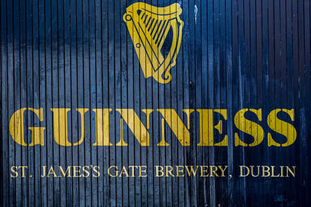 DUBLIN, IRELAND - APRIL 22, 2016: Outdoor front closeup of company name at the historic old factory building wooden gate at Guinness St. JamesÂ´s Gate Brewery in Dublin Ireland April 22, 2016.のeditorial素材