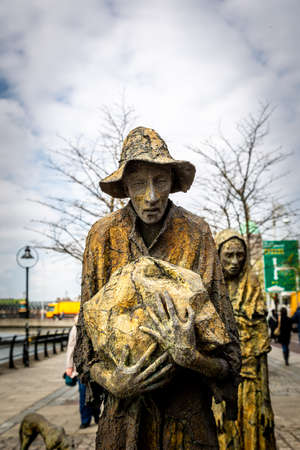 DUBLIN, IRELAND - APRIL 22, 2016: Irish culture with public art of history and powerty. Steel sculptures of worn people on a pedestrian walkway in Dublin Ireland April 22, 2016.のeditorial素材
