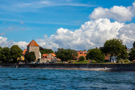 VISBY, SWEDEN - JULY 27, 2020: Beautiful summer seaside view of the old ancient city Visby. Recreation park area with people walking next to the sea in Visby Gotland July 27, 2020.のeditorial素材