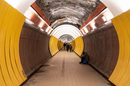 STOCKHOLM, SWEDEN - FEBRUARY 13, 2021: Perspective view of people in the pedestrian tunnel Brunkebergstunneln in Stockholm Sweden February 13, 2021.のeditorial素材