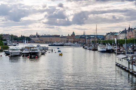 STOCKHOLM, SWEDEN - JULY 20, 2021: Relaxed twilight summer view of calm waters, city buildings, resturant and boats in the central parts of Stockholm Sweden July 20, 2021.のeditorial素材