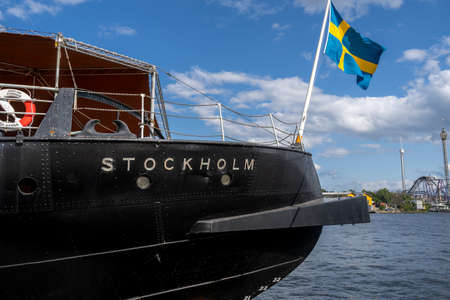 STOCKHOLM, SWEDEN - JULY 20, 2021: Side stern view of the old vintage steamship Sankt Erik with the Swedish flag in the stern moored in harbor in the central parts of Stockholm Sweden July 20, 2021.のeditorial素材