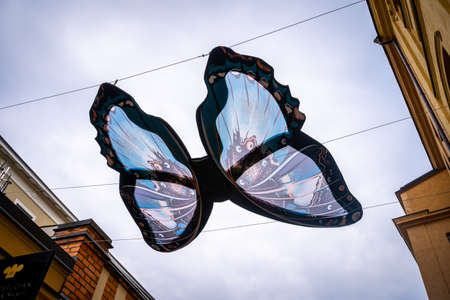 NORRKOPING, SWEDEN - JULY 27, 2021: Street decoration with a big blue fabric butterfly hanging over city street with sky above in Norrkoping Sweden July 27, 2021.のeditorial素材