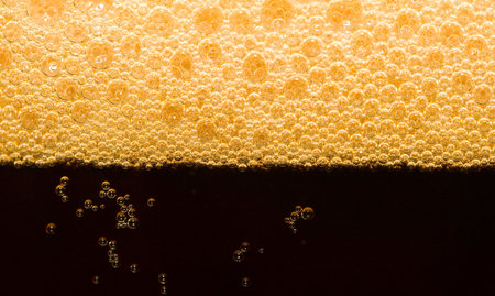 close-up dark beer with foam