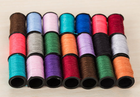 three rows of threads of diffrent colors