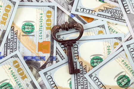 close-up old key on money backgroundの写真素材