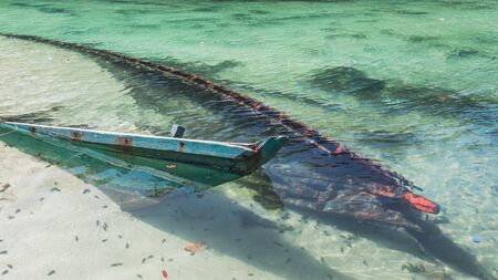 Sunken boat in shallow waterの写真素材