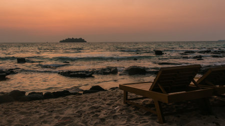 Two Sunbenches at sunrise on the coast, sunrise colors, relaxed mood, holiday and vaccation