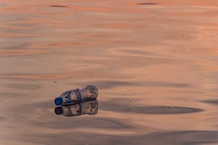 Plastic bottle floating on the riverの写真素材