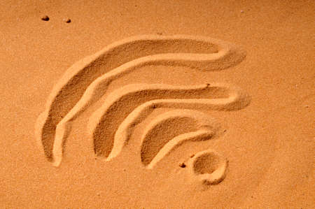 Wifi symbol in sand beach の写真素材