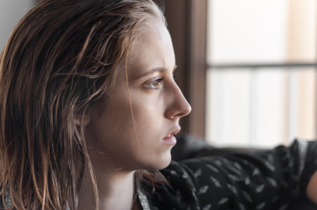 Blonde girl photographed inside a house.