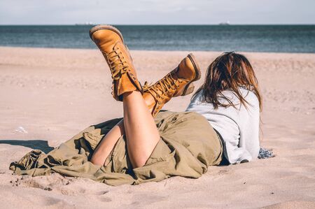 Young girl, wearing casual clothes, photographed on the beach in winter.の写真素材