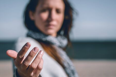 Young girl, wearing casual clothes, photographed on the beach in winter.の写真素材