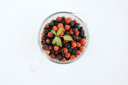 Pitcher of glass with red mulberry and blackberry