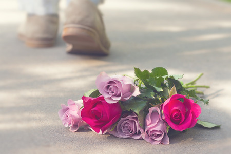 rose bouquet left on groundの写真素材