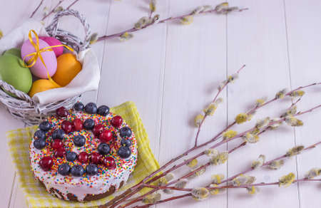 easter composition with the decorated cake and colored eggs on a white wooden backgroundの写真素材