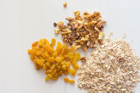 oatmeal raisins walnut  on a wooden tableの写真素材