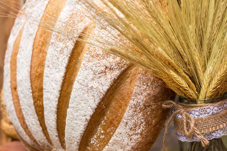 fresh bread from the white flour with rye spikeletsの写真素材