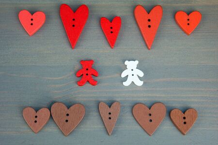 Two bears with hearts on grey wooden background. Button bears love. Button love. Wooden buttons. Post card for the Valentine.の写真素材