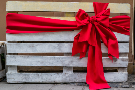 Wooden pallet with red bow. Special gift.の写真素材