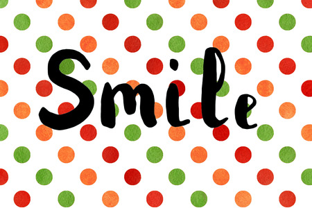 The word smile. Lettering. Brush calligraphy on colorful polka dot watercolor texture. Positive inspirational quote on polka dot background. Lettering for posters, cards and social media content.の写真素材