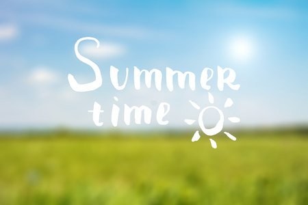 Summer time hand drawn lettering. Hand drawn phrase Summer time on the sky and grass blured background. Inscription for summer card, banner, poster, party invitation or t-shirt design.の写真素材