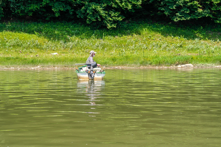 Dnister River canyon, Ukraine - July, 2017: Fishermen on a boat ride along the Dniester River.のeditorial素材