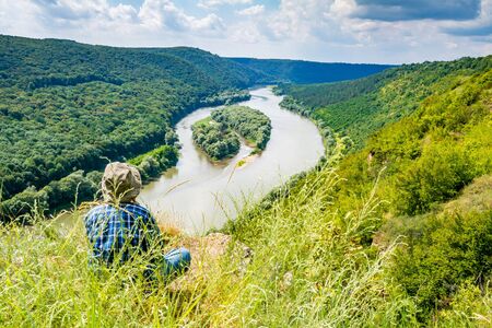 Girl on a top of mountain above river canyon. Aerial view of Yin and Yang islands on the Dnister River. National Park Dnister Canyon, Ukraine.の写真素材