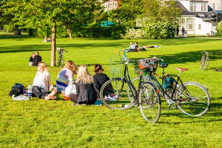 Copenhagen, Denmark - May, 2019: People relaxing at the King's garden next to Rosenborg castle.
