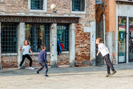 Venice, Italy - October, 2019: Street life in Venice. Children playing football on the streets of Venice.のeditorial素材