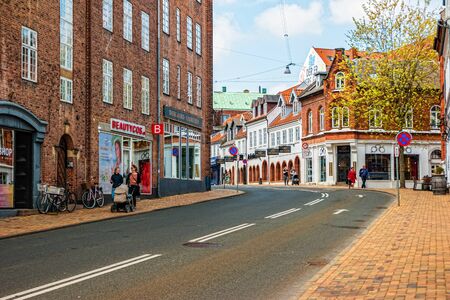 Odense, Denmark - May, 2019: Street life in Odense. People spend time downtown.の写真素材