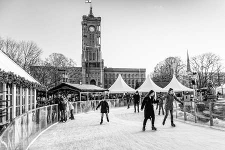 Berlin, Germany - December, 2019: People on ice skating rink on Christmas Market at Alexanderplatz.のeditorial素材
