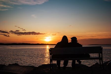 Happy mature couple silhouette at sunset in Fazana, Croatia.の写真素材