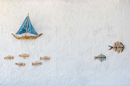 Boat and fish - picture on the wall of a restaurant on the on the Halki Island near Rhodes, Greece.の写真素材