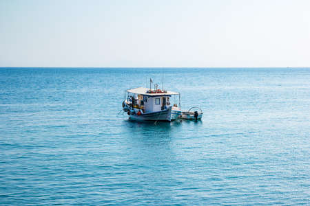 Boats in port at small fishing village of Kamiros Skala. Rhodes, Greece.の写真素材