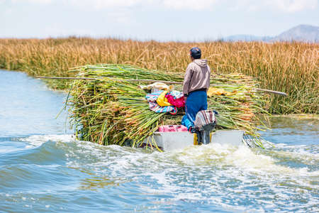 People on the floating Uros Islands on Lake Titicaca in Peru.の写真素材