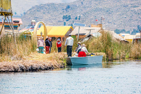 Uros, Peru - October 2021: People on the floating Uros Islands on Lake Titicaca in Peru.のeditorial素材