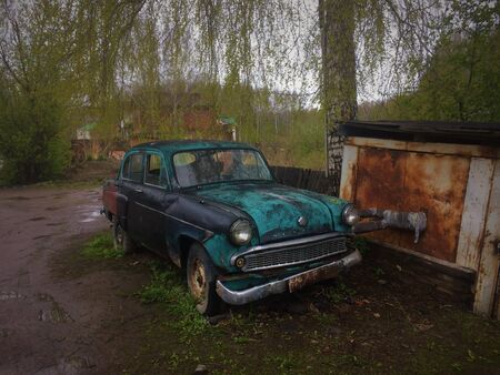 Old Blue Car Near Old Brown Orange Garageの写真素材